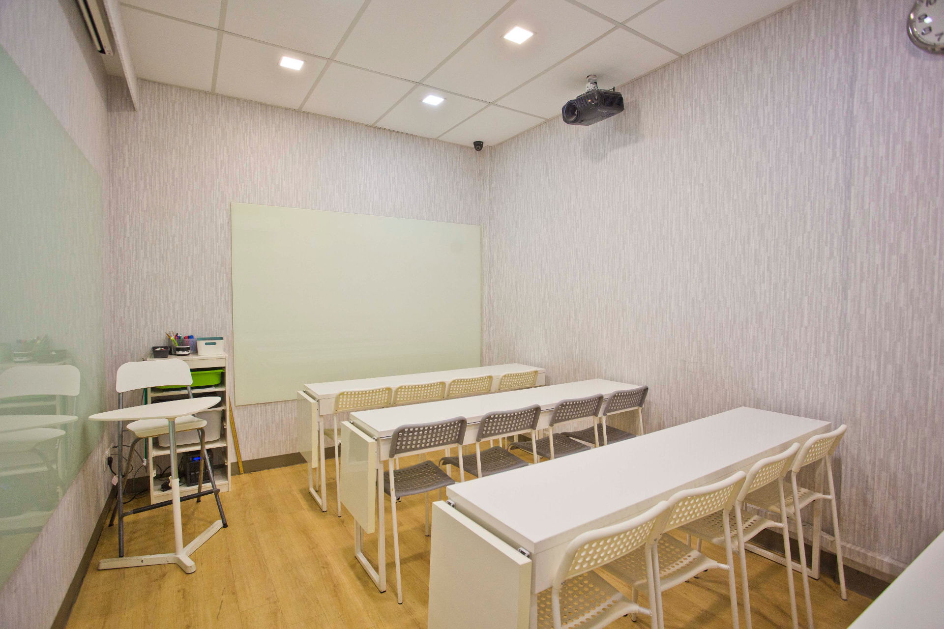 AZKEN classroom with ceiling projector and white tables for group lessons