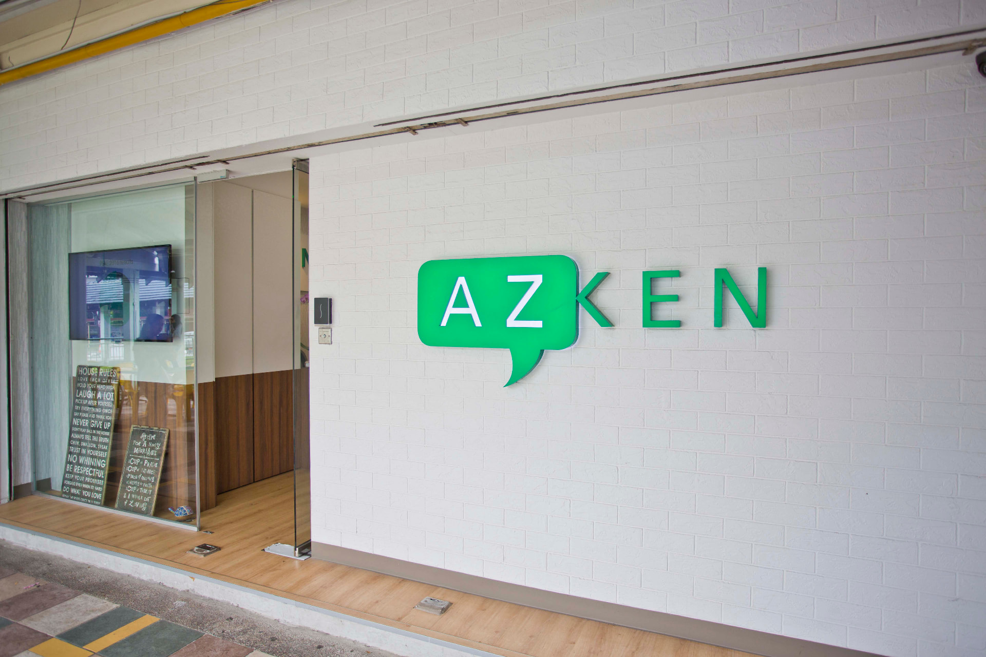 AZKEN tuition centre storefront entrance with the green AZKEN speech-bubble logo